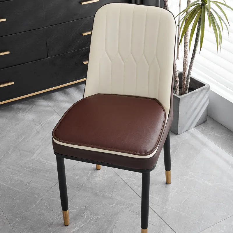 Beige leather horseshoe-shaped seat cushion with anti-slip base on a wooden chair