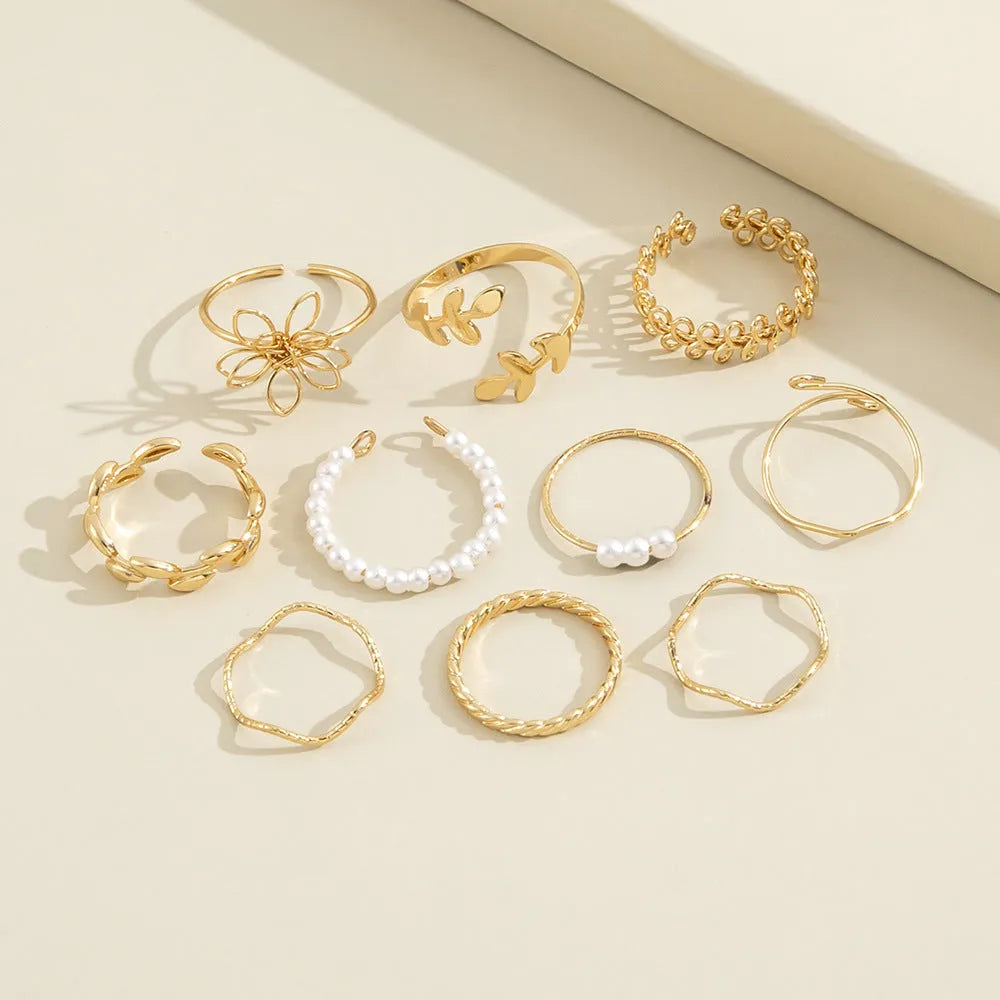 Gold tone openwork flower ring with electroplated glossy finish and women's jewellery design
