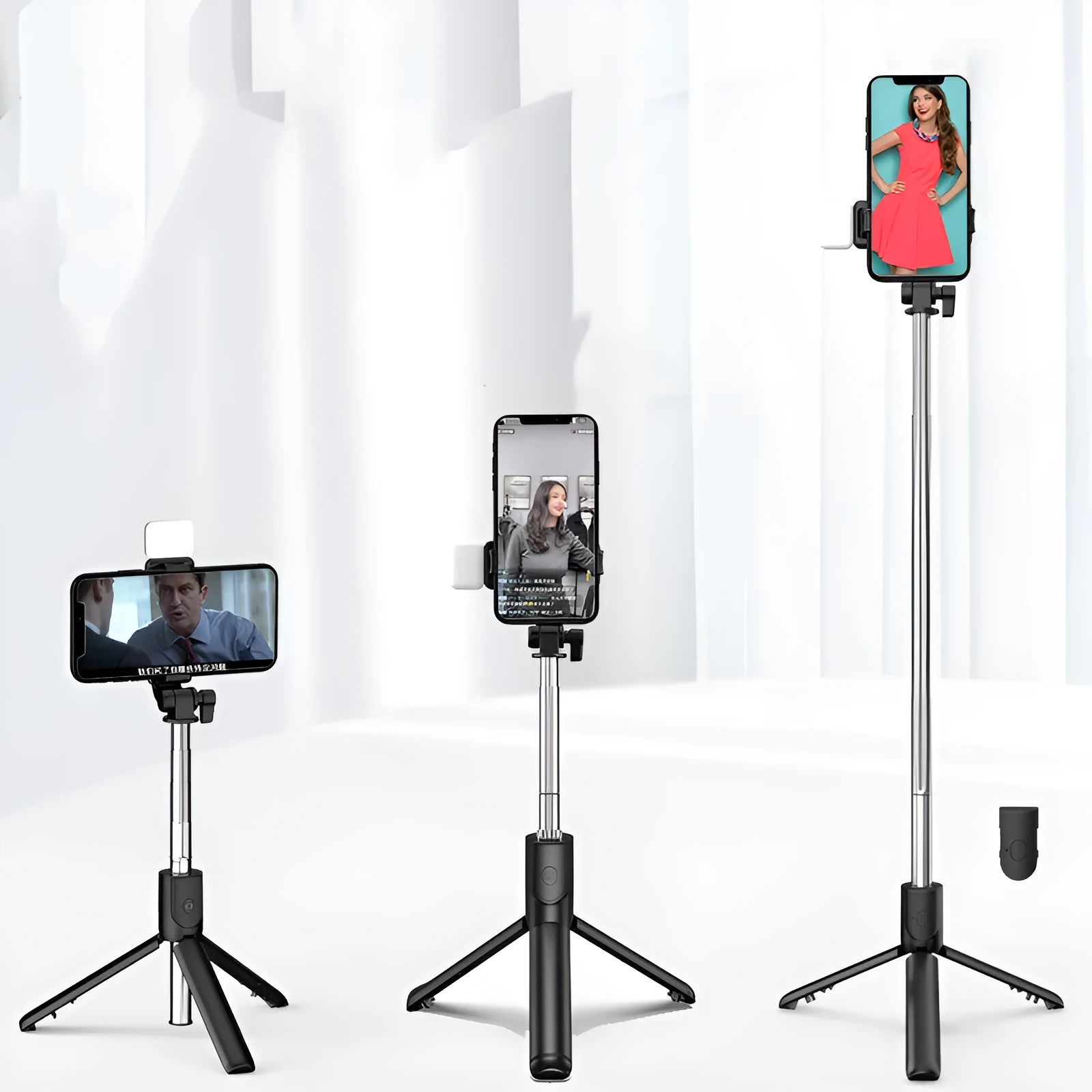 Black Bluetooth selfie stick with extended tripod legs and a phone mounted in its 360-degree rotating holder.