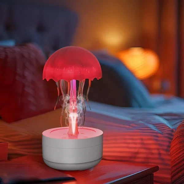 White jellyfish-shaped desktop humidifier and essential oil diffuser with colourful night light on.