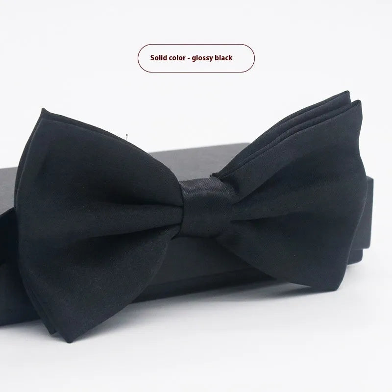 Men's flat head style polyester bow tie in a solid colour, shown with adjustable neck strap.