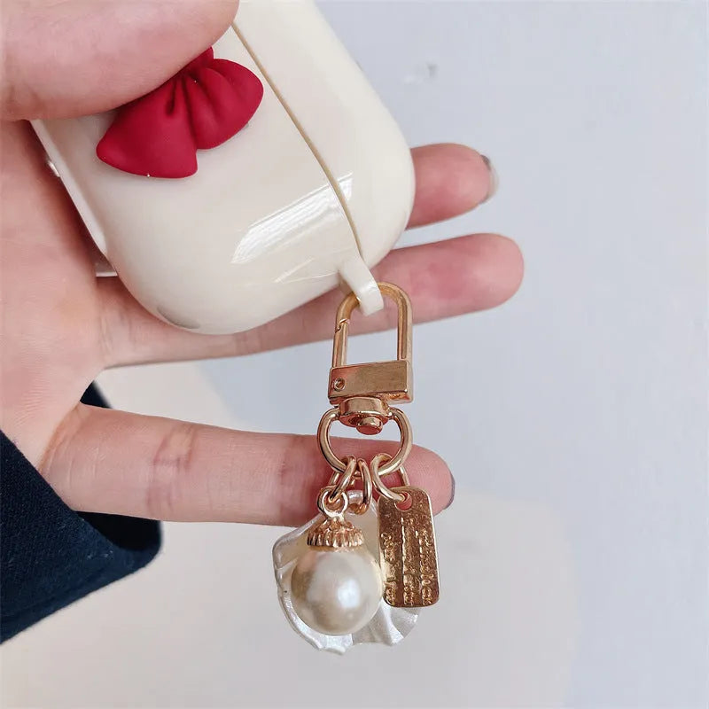 Beige AirPods case with red bow shell design, clamshell TPU earphone cover