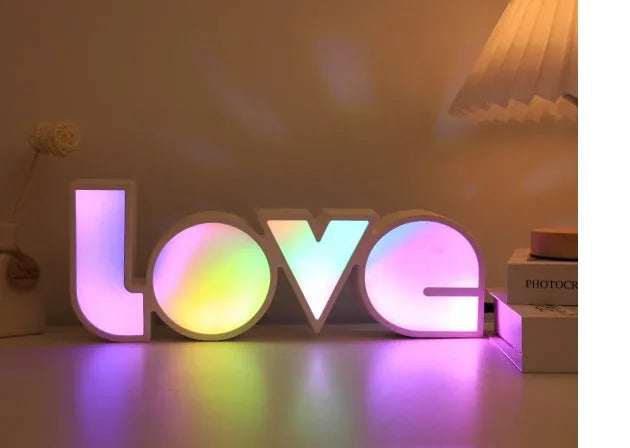 Colourful LED love light decorative lamp with plastic shell on a table