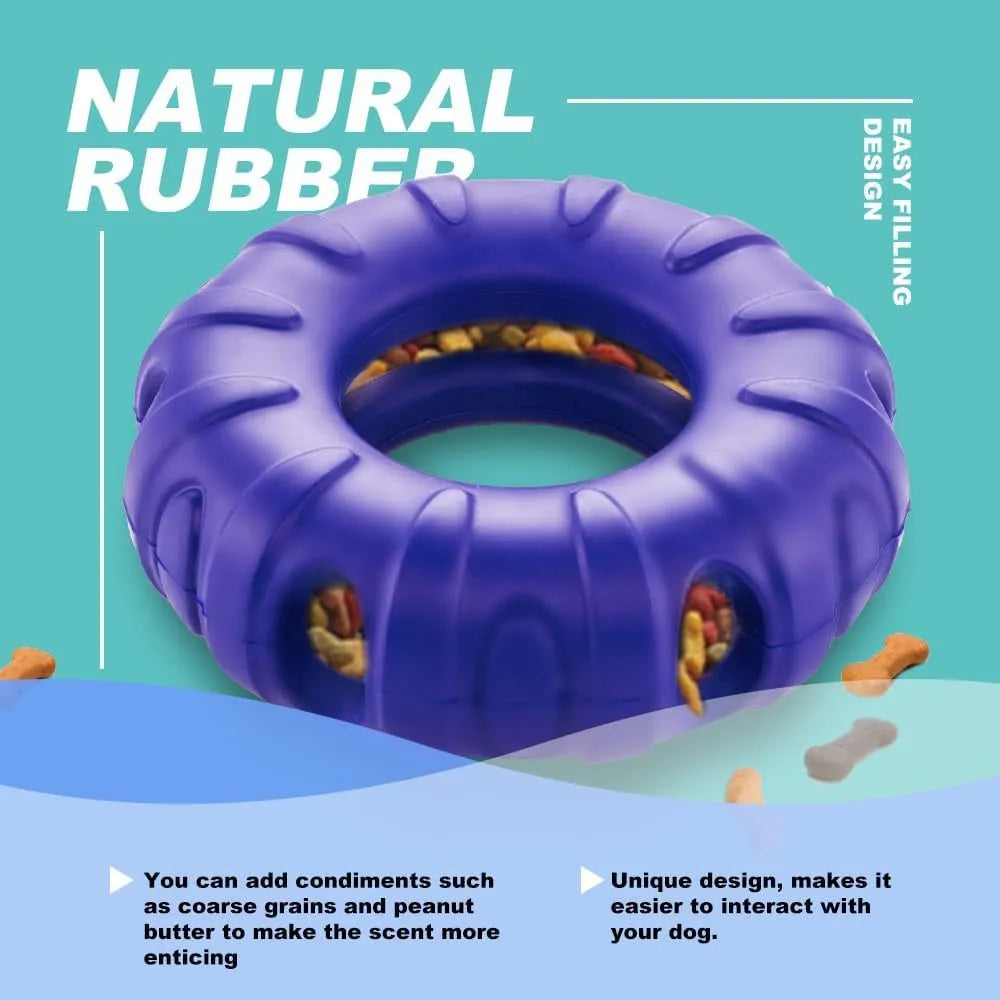 Blue rubber tire-shaped dog chew toy with oval openings for treat dispensing on a white background.