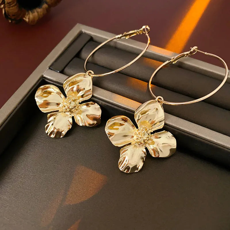 Silver needle metal flower earrings with geometric floral design in gold or silver colour