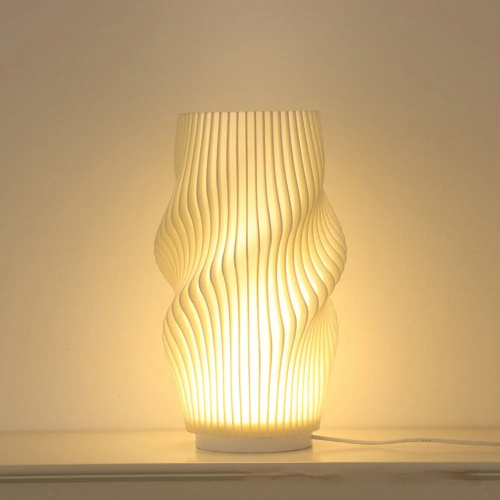 3D printed cylindrical vase night lamp in wood colour finish on a modern bedside table