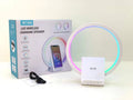 White smart Bluetooth speaker with wireless charging pad, ambience light, and card slot on a desk