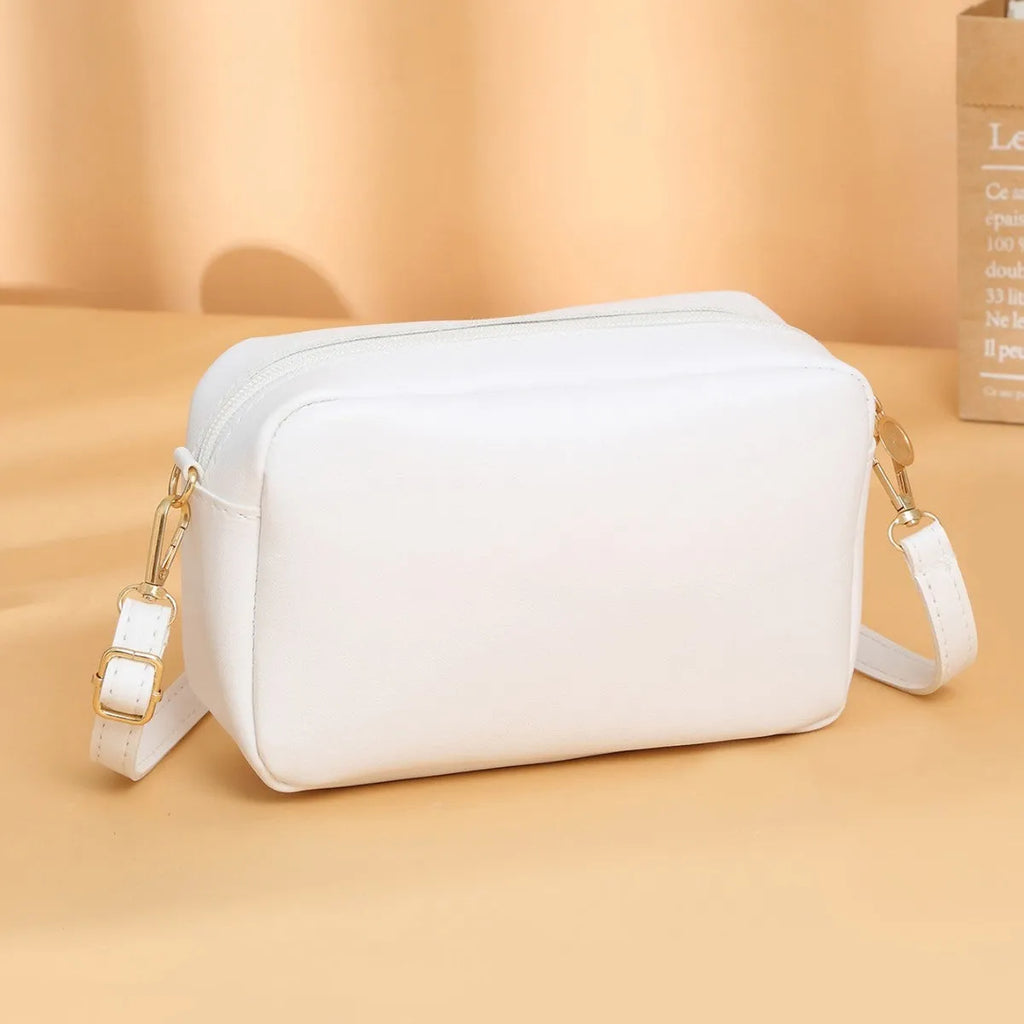 Women's solid colour PU leather shoulder bag with three-dimensional pocket and square shape.