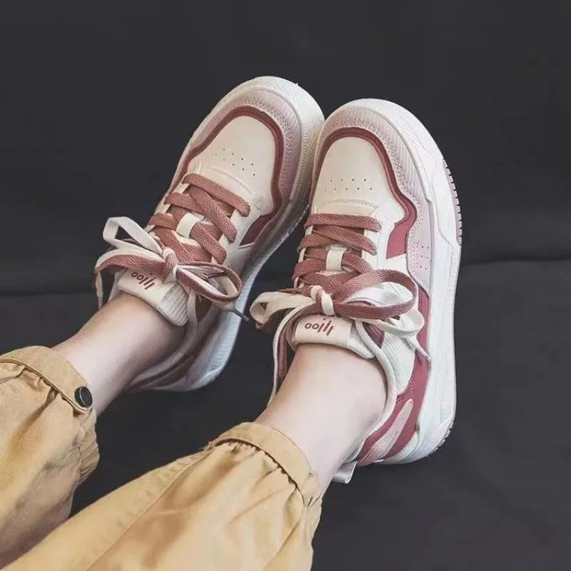 Women's beige and pink low-top rubber sneakers with height-increasing sole on a white background