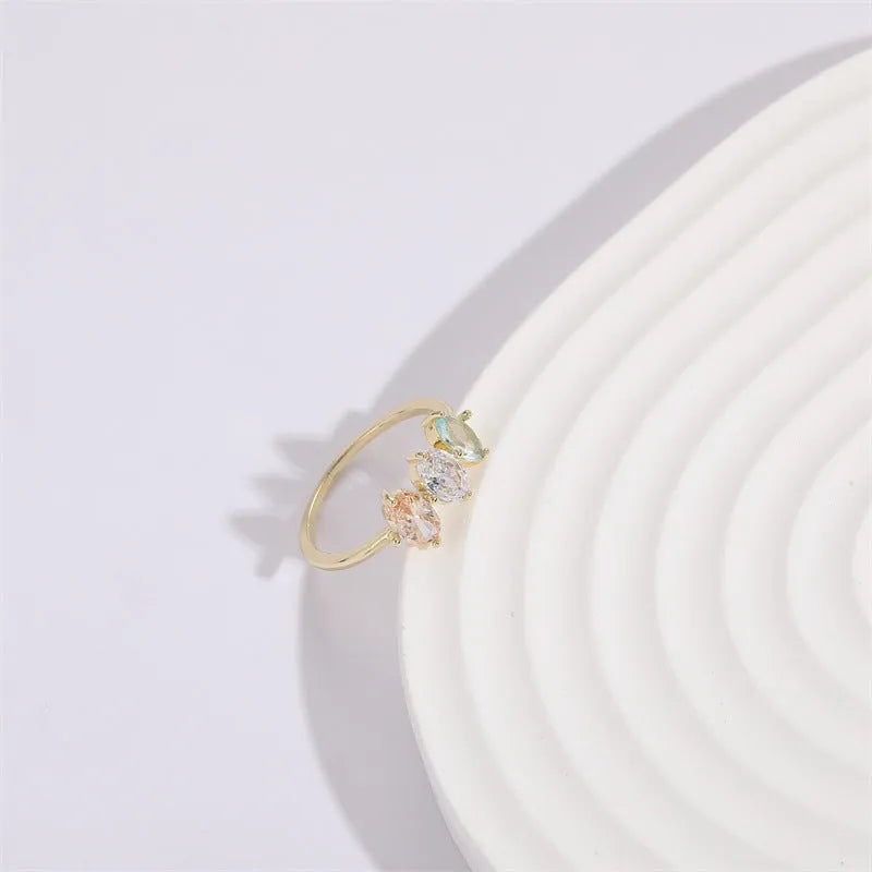 Geometric triangle ring with tricolour zircon stones in horse eye pattern and gold colour finish
