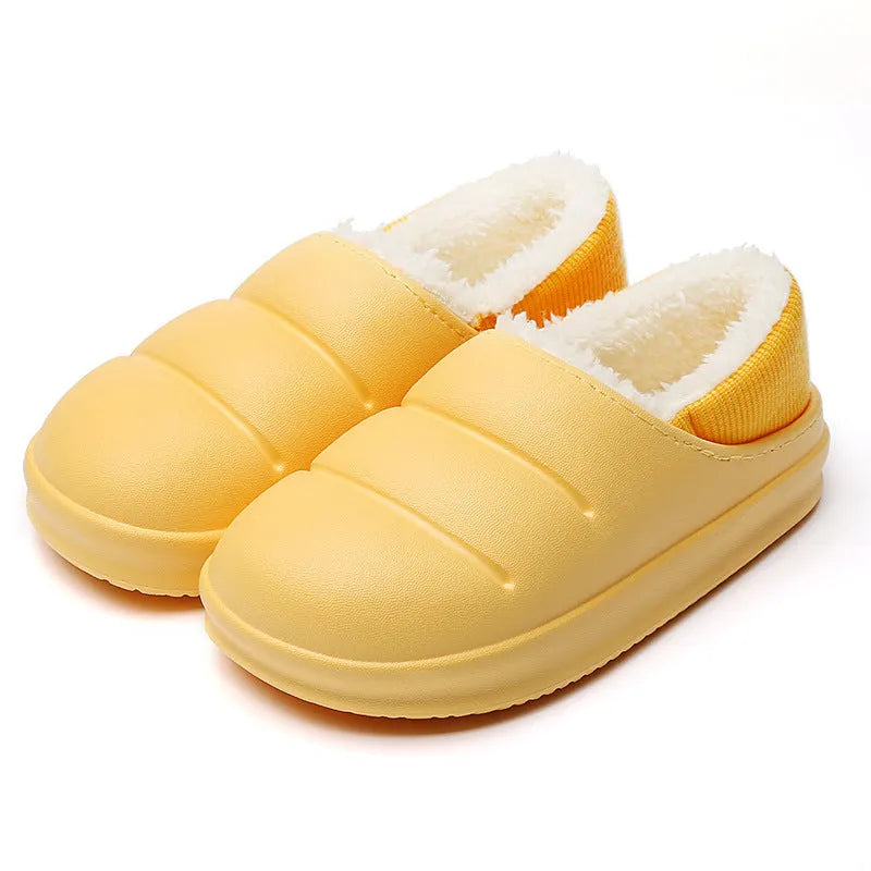 Green waterproof EVA garden slippers with plush lining and a non-slip sole, shown on a wooden deck.