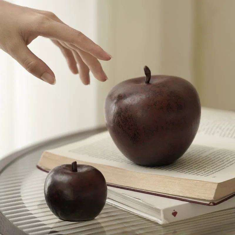 Ceramic apple decoration ornament on a desk, shown in large and small size options.