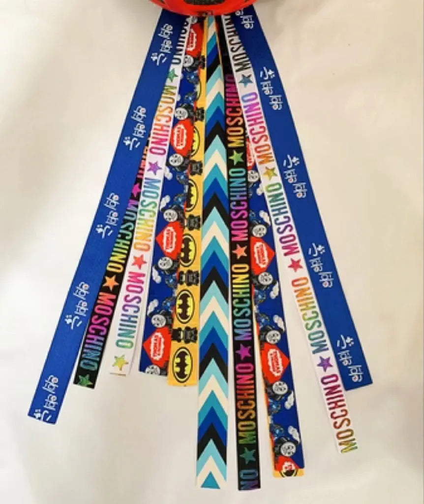 Colourful decorative ribbon streamers attached to a children safety helmet for skating or skiing