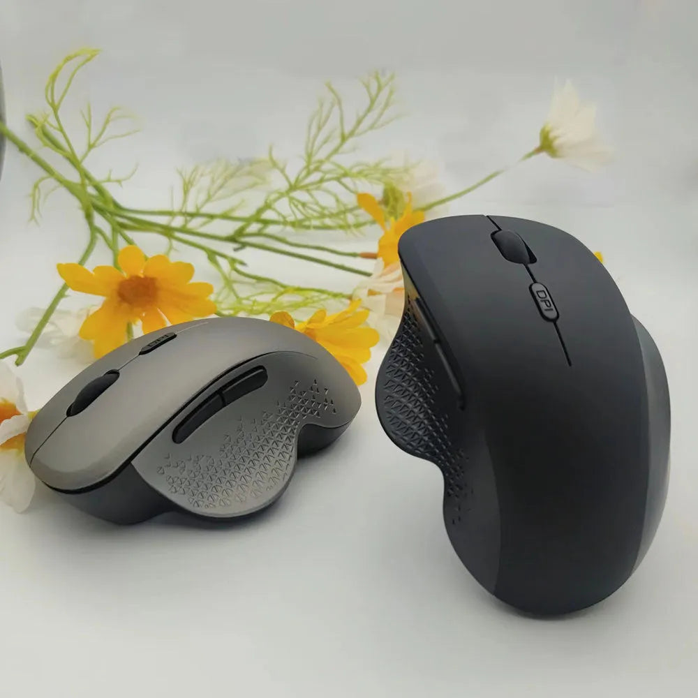 Black rechargeable wireless mouse with USB cable next to laptop showing compact 112mm size