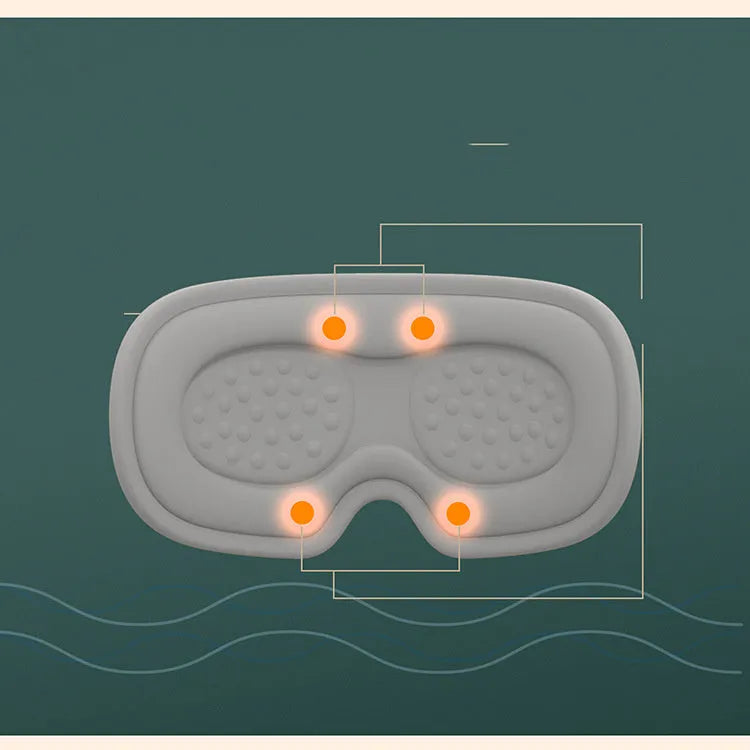 Green portable eye steam massage goggles with USB cable on a table.