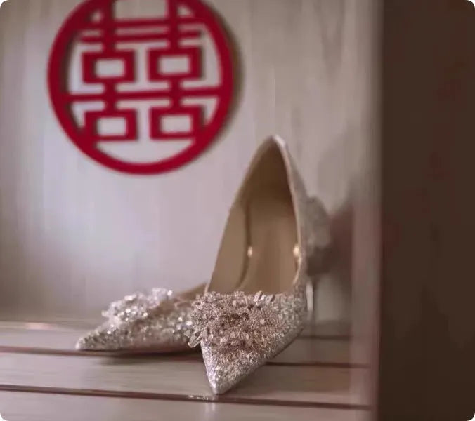 Champagne coloured pointed toe bridal heels with rhinestone patterns on a fine heel.