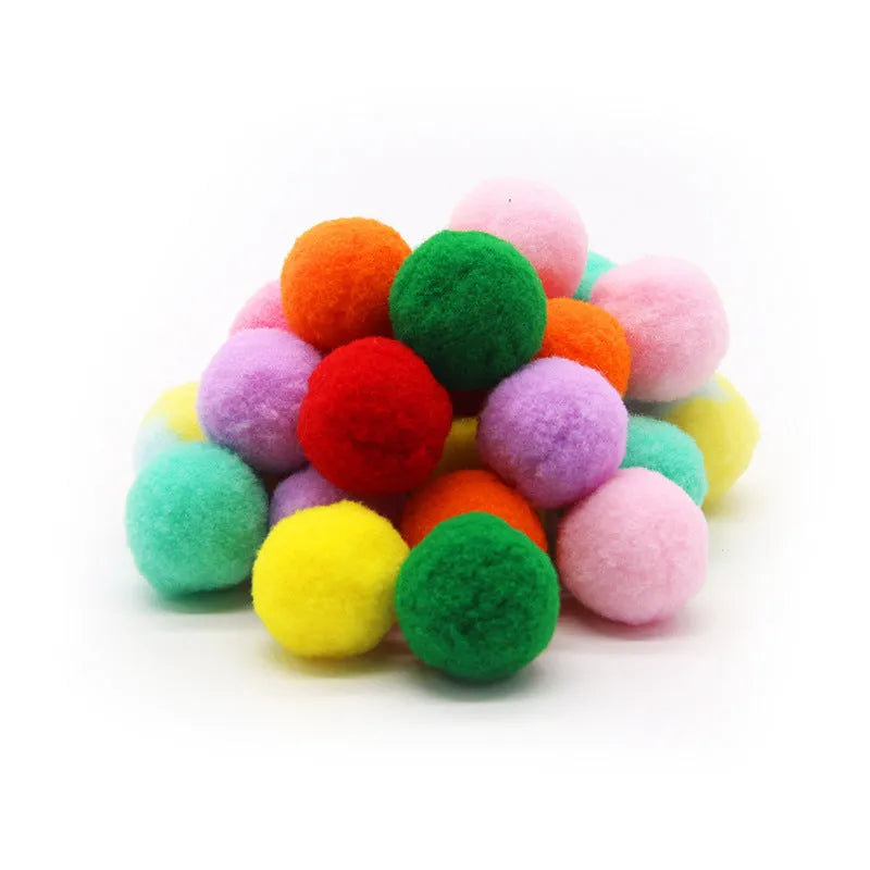Pet toy launcher gun and soft plush balls for interactive play with cats and dogs.