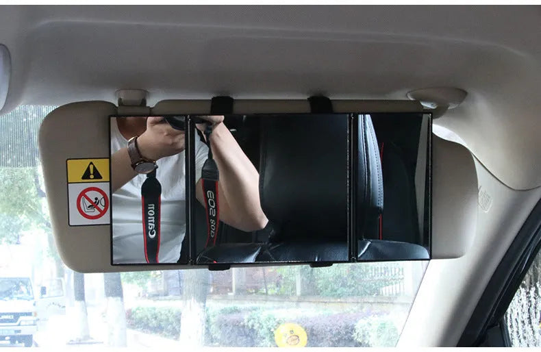 Silver folding car makeup mirror shown open and closed, next to a car visor.
