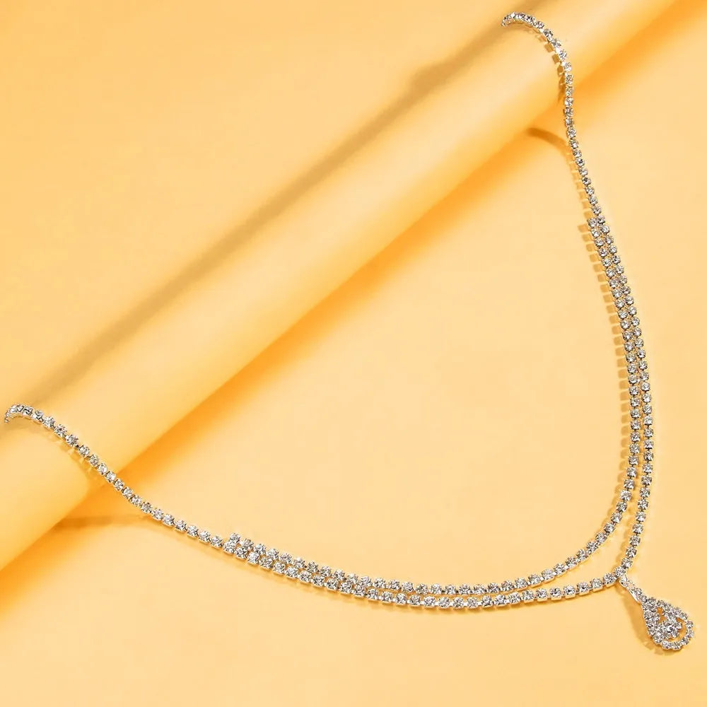 Gold or silver water drop pendant waist chain for women with rhinestone and tassel accents, lobster clasp
