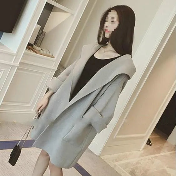 Plus size woman wearing a thin grey cotton coat with lace detail, loose fit, and long sleeves.