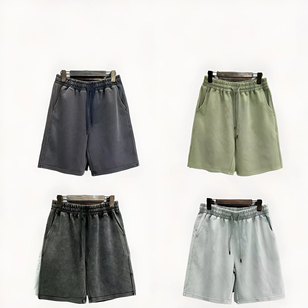 Man wearing charcoal black distressed cotton casual shorts with a loose straight fit.