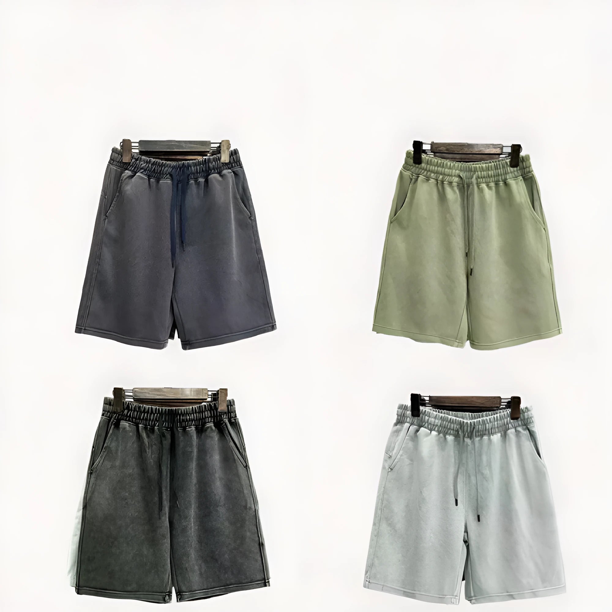 Man wearing charcoal black distressed cotton casual shorts with a loose straight fit.