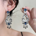Vintage court style earrings with atmospheric blue crystal and chamfered square grain geometric shape in E7744 colour