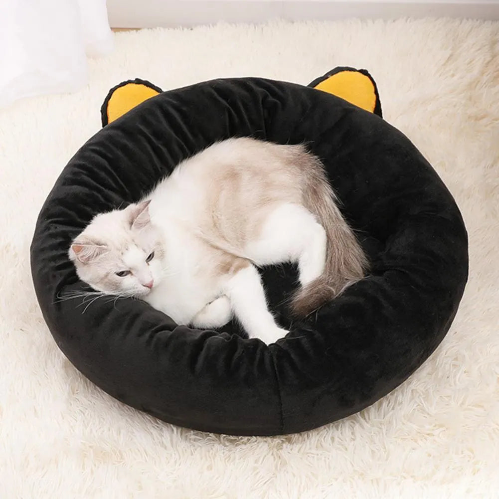 Black cat shape velvet pet nest bed with raised edges, 50cm diameter, on floor