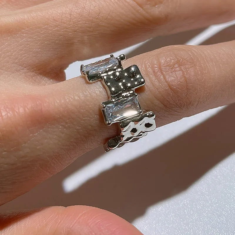 Geometric cross zircon ring in silver-plated metal with open design and three-dimensional decoration