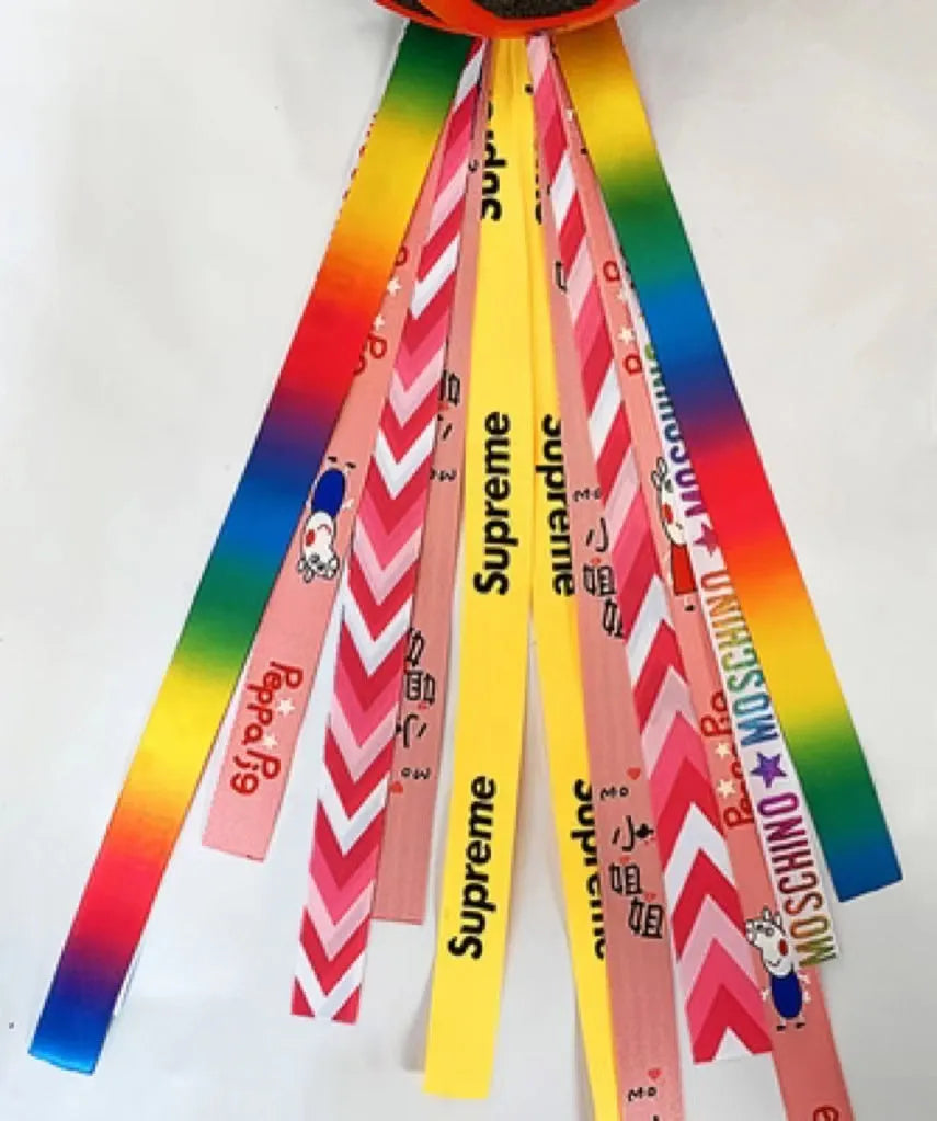Colourful decorative ribbon streamers attached to a children safety helmet for skating or skiing