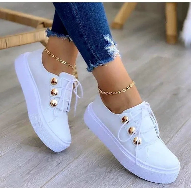 Women's white lace-up flats sneakers with metal rivet detailing and round toe design