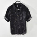 Man wearing a loose-fit black short-sleeved polo shirt, cardigan style, for casual summer wear.
