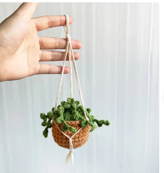 Green and white knitted rope car plant ornament with 8cm base and hanging rope.