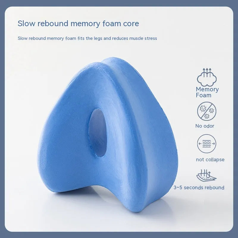 Heart-shaped dark blue memory foam leg pillow for adult knee or ankle support.