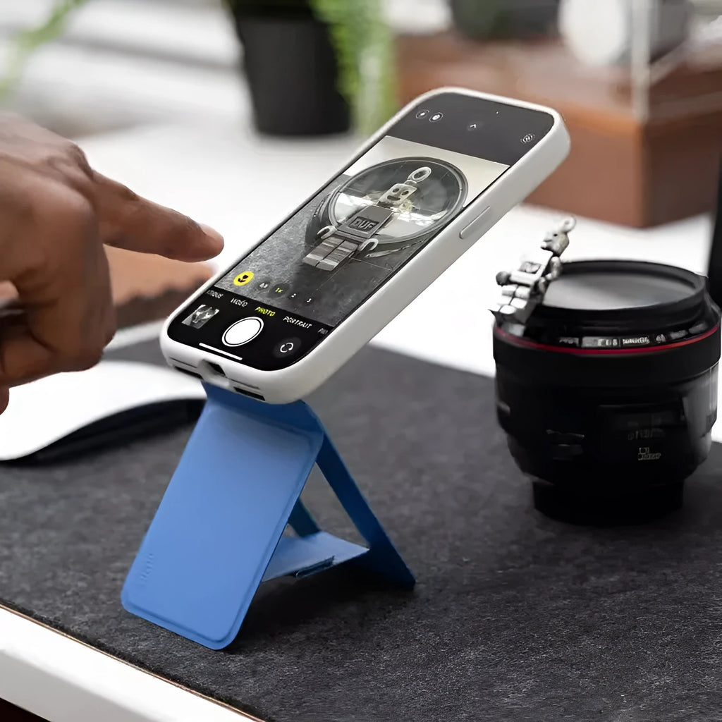 Magnetic mobile phone holder and case in leather with built-in stand, shown in grey.