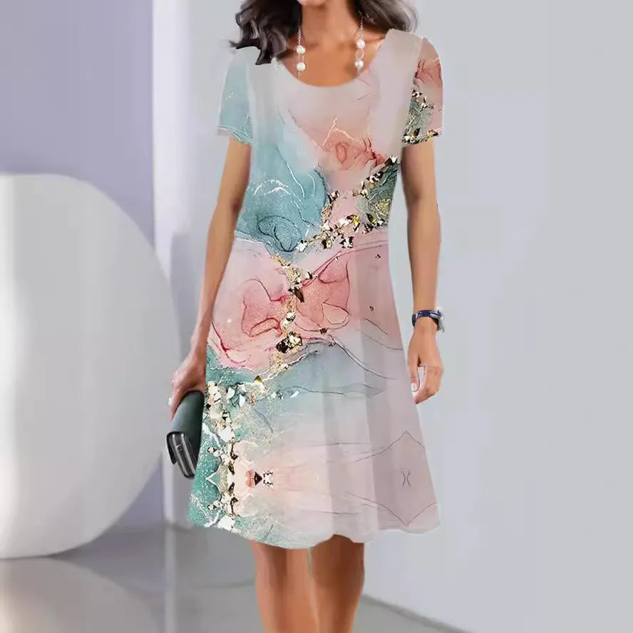 A model wearing a light blue botanical print midi dress with short sleeves and an A-line skirt.