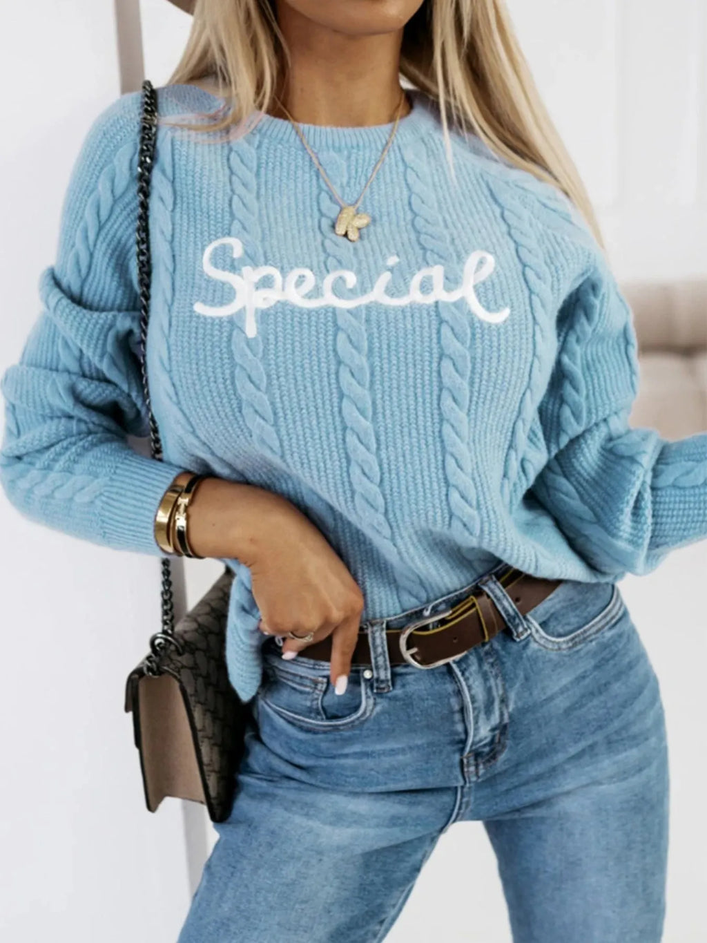 Blue crew neck pullover with embroidered letters in street fashion style