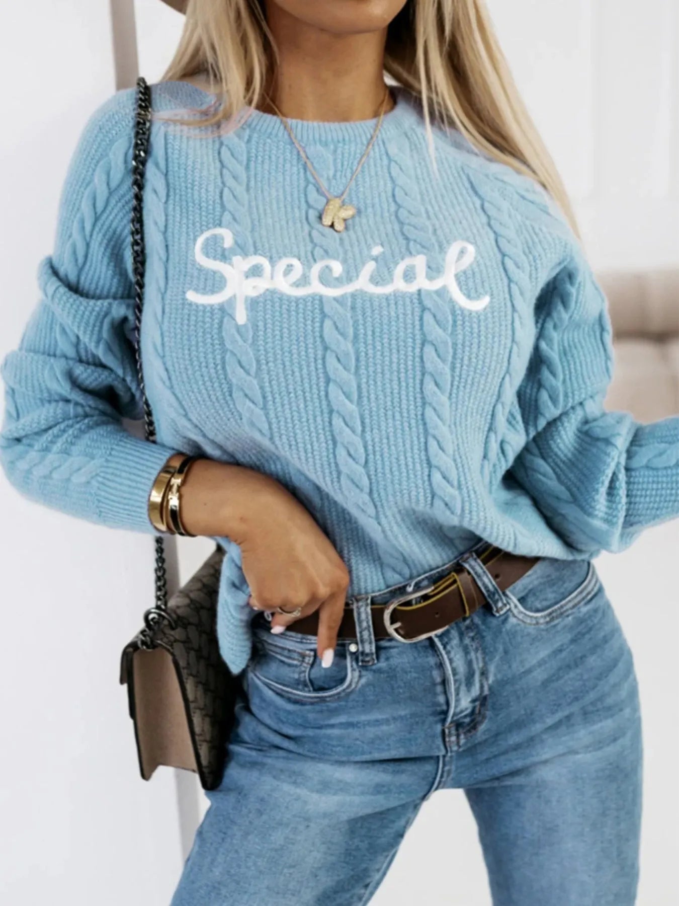Blue crew neck pullover with embroidered letters in street fashion style