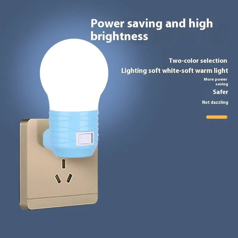 Plug-in bedside baby night light in white shell with modern round design on a table.