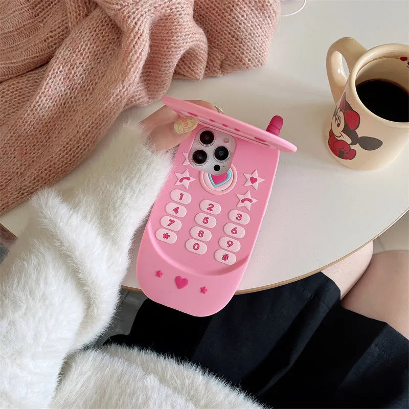 Light pink silicone flip phone case with mirror for iPhone, showing cute cartoon design.