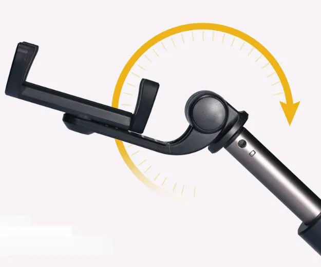 Aluminium Bluetooth selfie stick with tripod base and remote control next to a smartphone.
