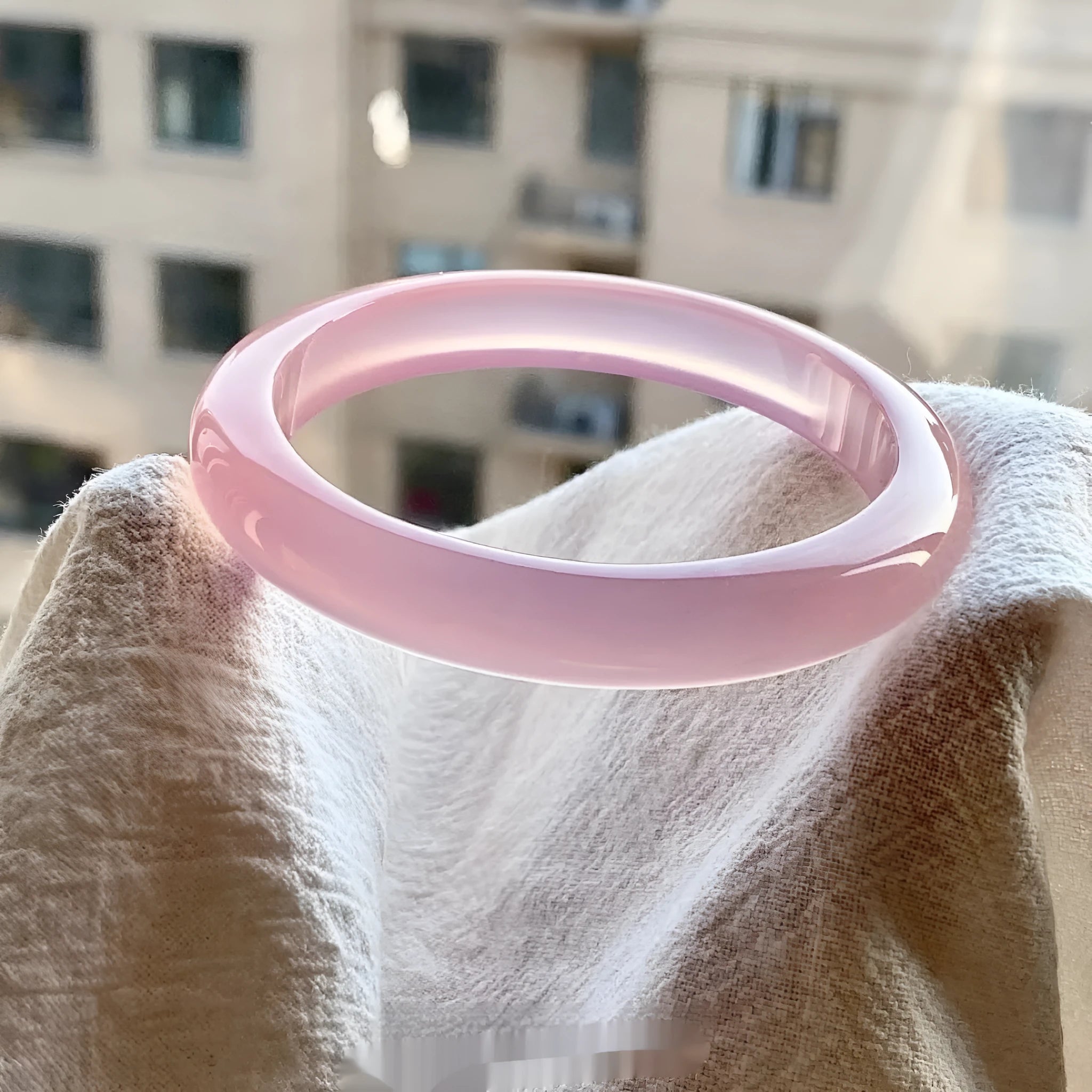 Natural agate wide tyre bracelet showing colour variations including pink, white, blue and green options