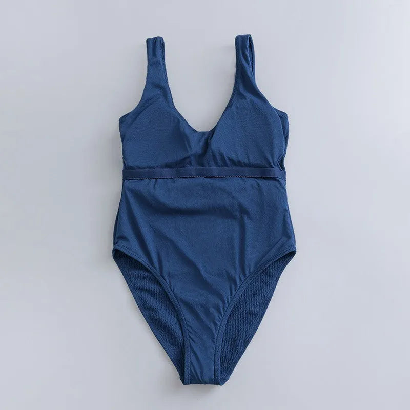 Navy blue women's one-piece swimsuit with triangle neckline and built-in chest pads