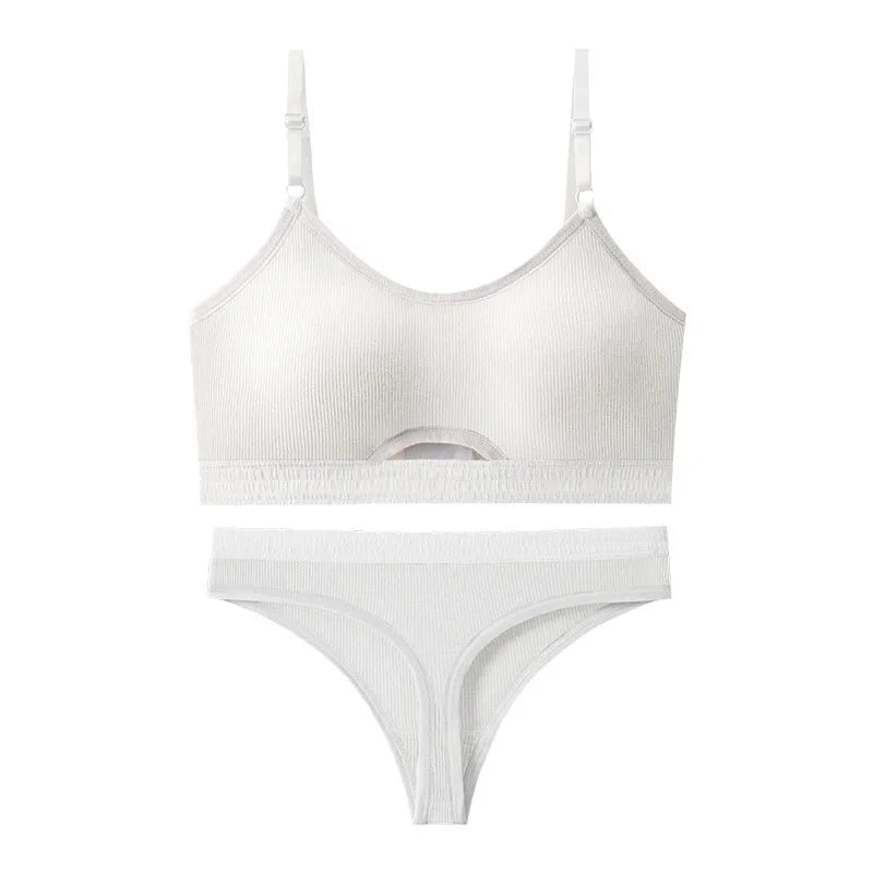 Women's contrast back sports bra vest and briefs set in black with underwire and padding.