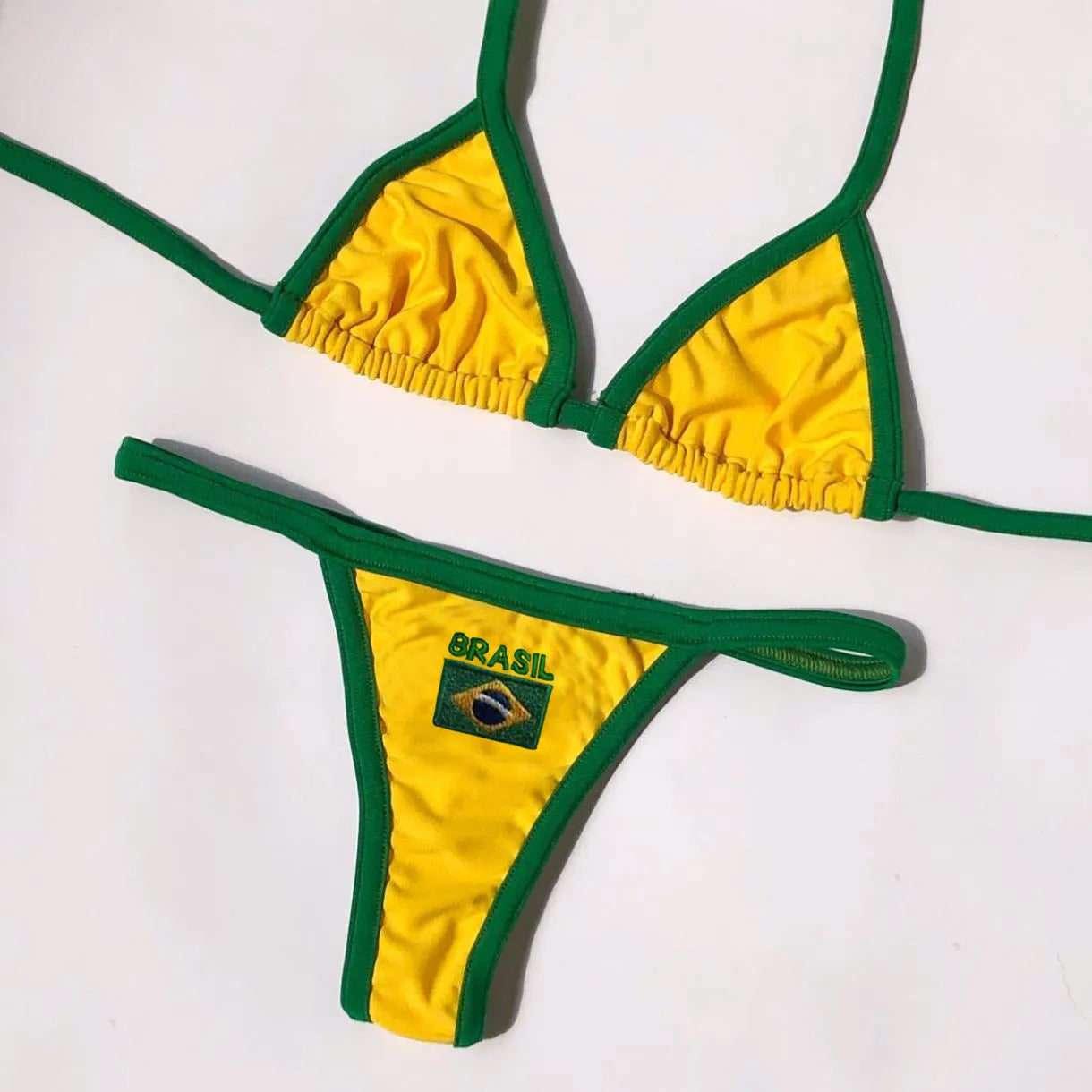 Yellow women's T-back bikini set with shorts bottoms on a mannequin.