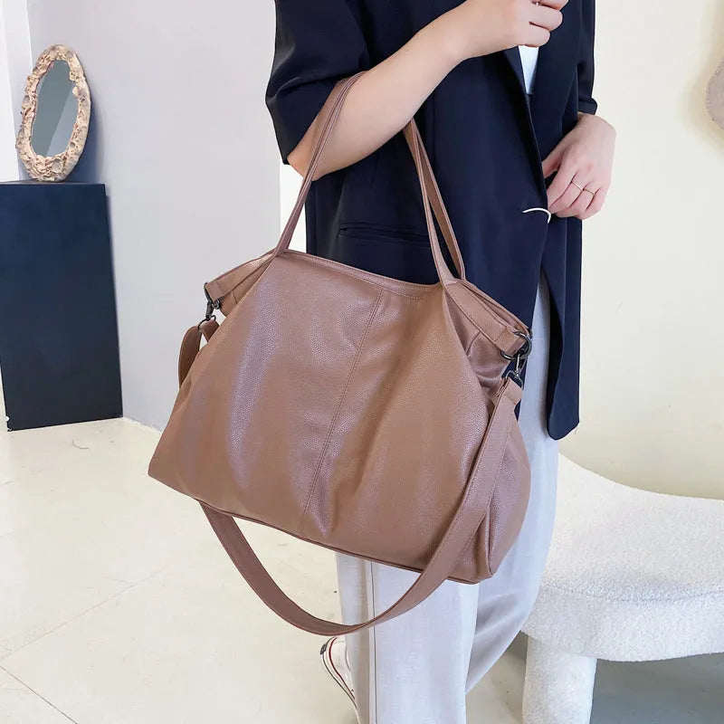 Large soft black PU messenger tote bag with car suture detailing and a long shoulder strap