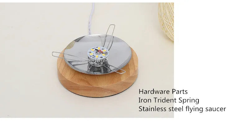 Brown hemp rope Sepak Takraw ball desk lamp with solid wood base on a desk.
