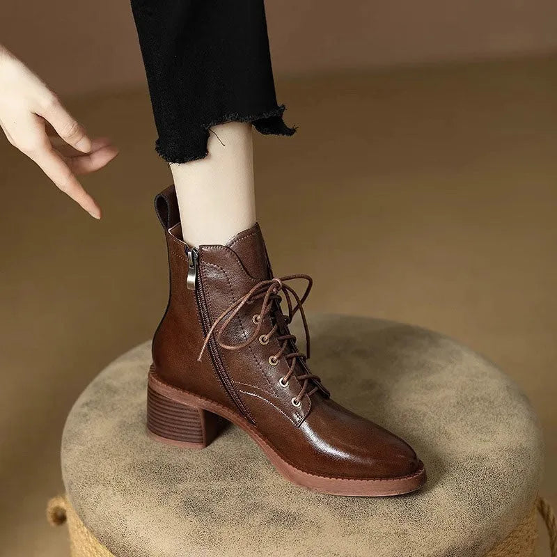 Women's black pointed toe short tube ankle boots with 5.5cm heel on wooden floor