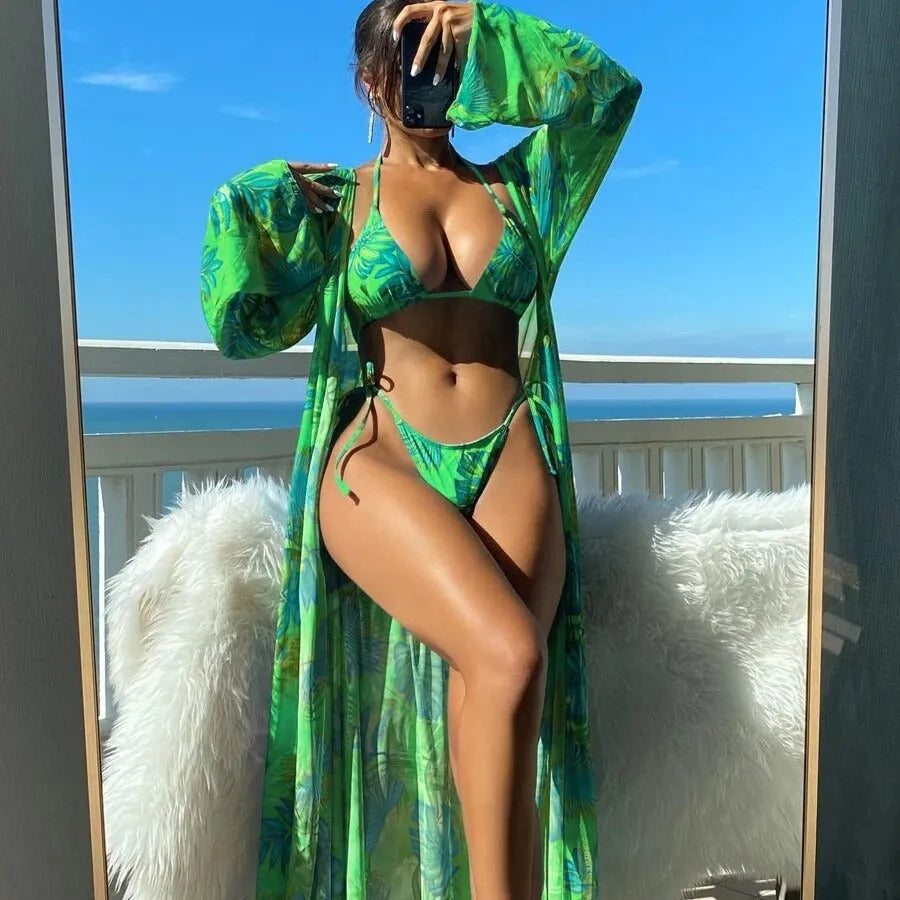 Women's long sleeve bikini set with floral pattern and matching robe on a hanger.