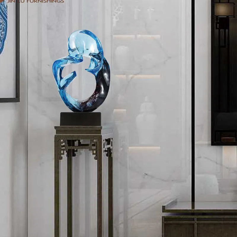 Transparent resin ornament with polished surface in blue colour on shelf